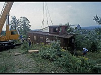 1980 caboose being hoisted by crane